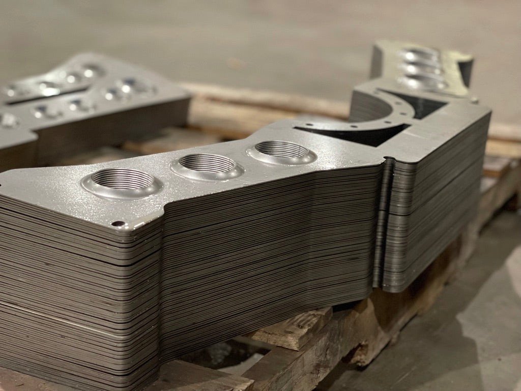 Stacked laser-cut sheet-metal parts with dimple-die-formed holes