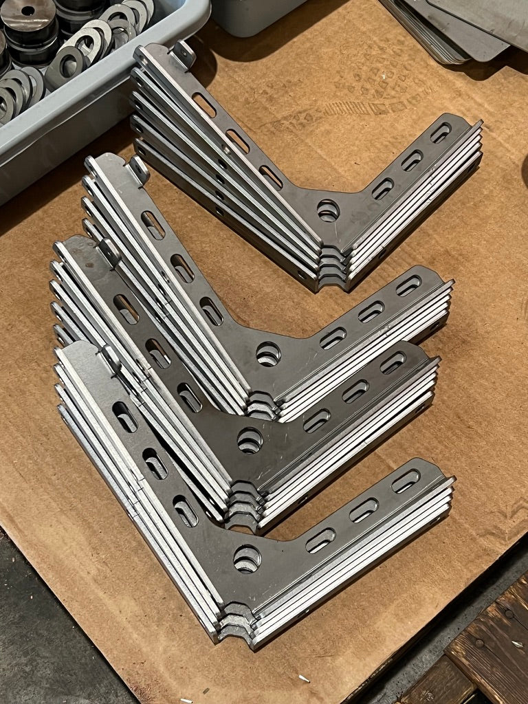 Stacks of laser-cut and press-brake-formed brackets at KRAZO Laser