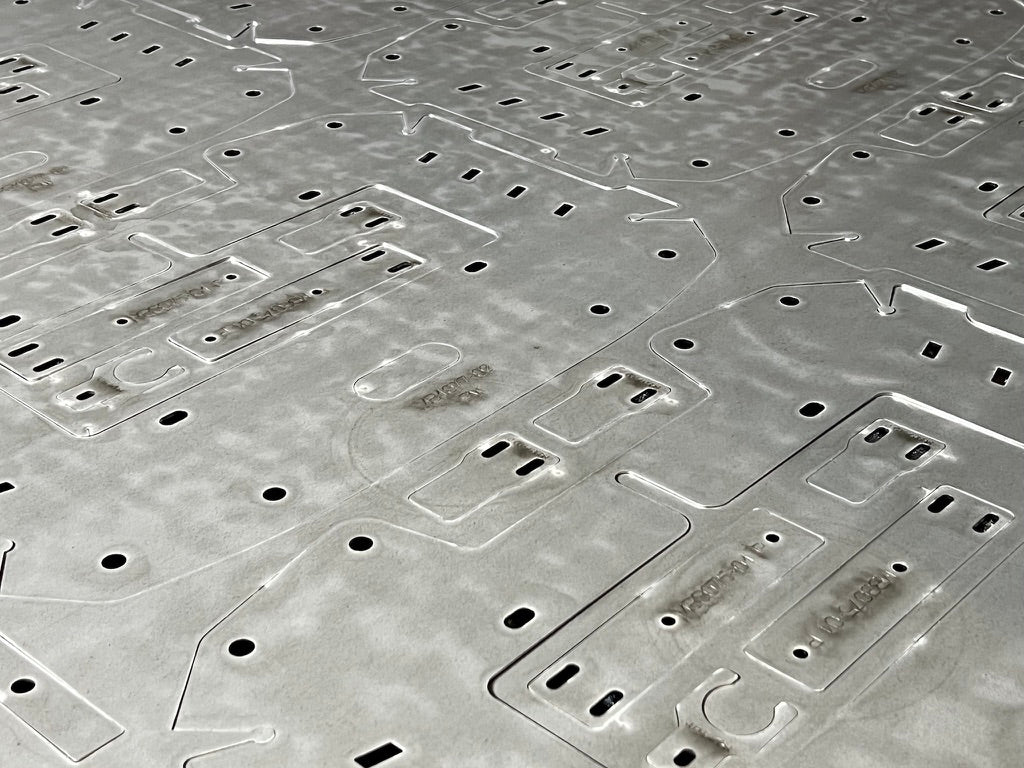 Laser-cut profiles nested in a metal sheet at KRAZO Laser